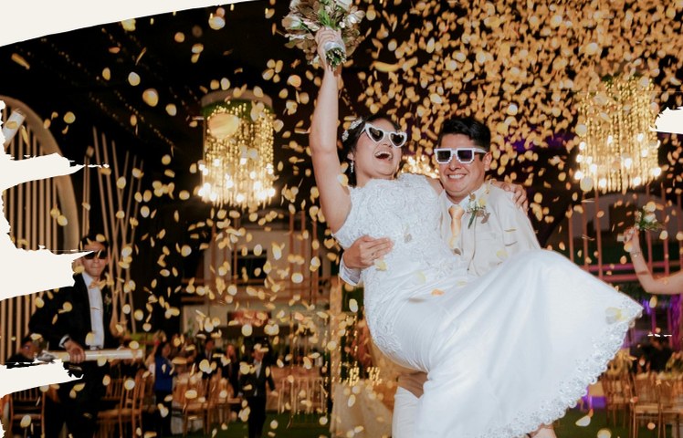 Couple lifted in a shower of gold confetti