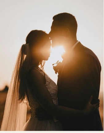 Couple silhouetted against the sunset
